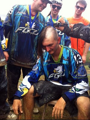 Robert Sims having his head shaved by the FGCU Paintball Team